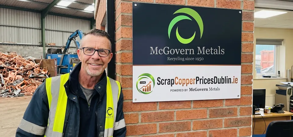 Keith Stewart O’Brien, Yard Manager, beside the McGovern Metals and Scrap Copper Prices Dublin signs at the yard